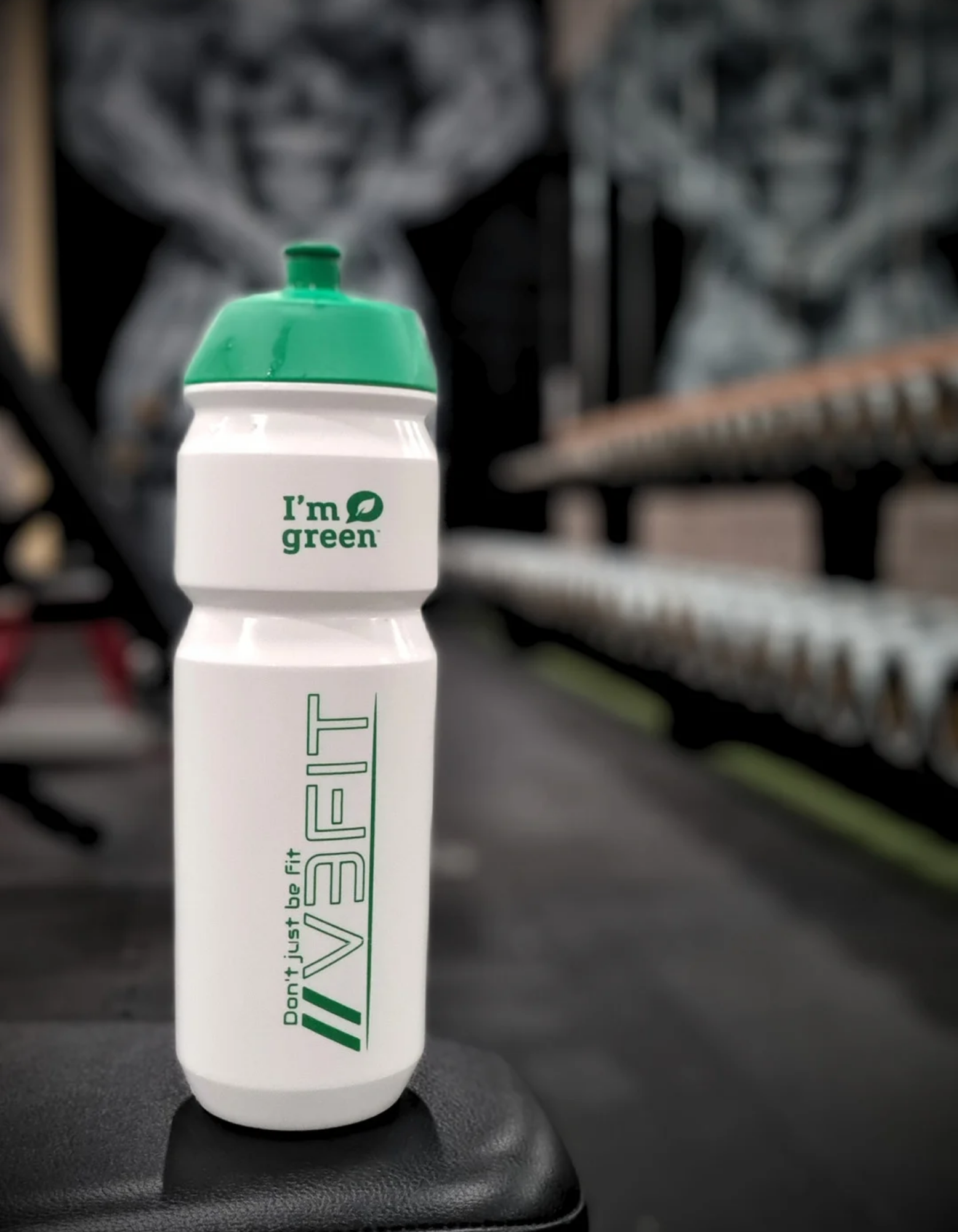 A photograph showcasing the V3Fit bioplastic water bottle (750ml) against a gym background.